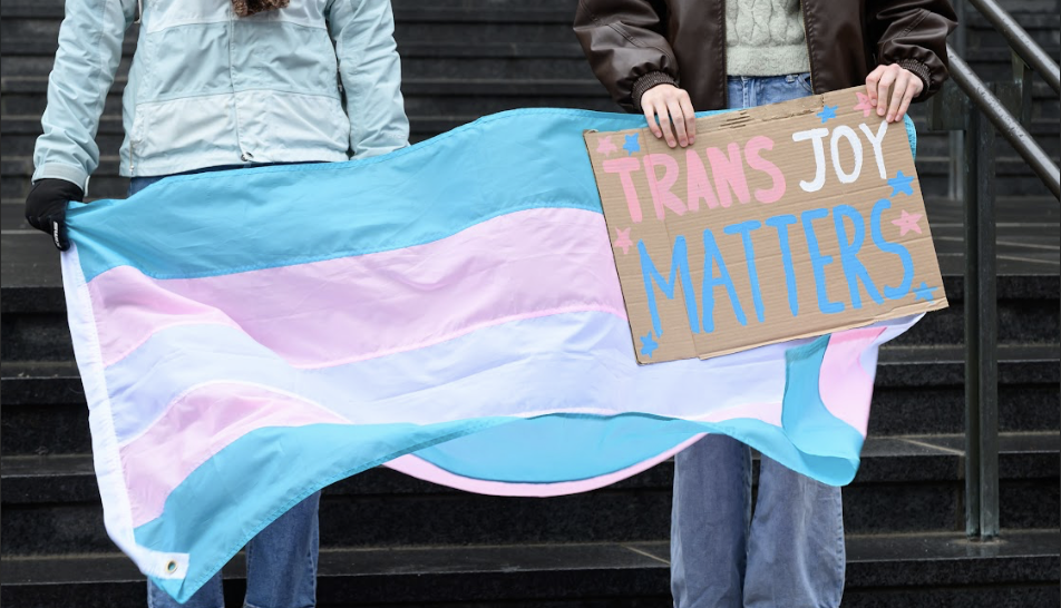 Protest image emphasizing that trans joy matters.
